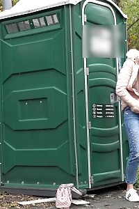 Blonde Katy Squats To Piss Against Portaloo