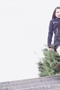 Black Haired Babe Pisses Down Concrete Steps