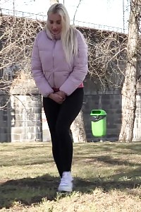 Blonde Pretty Squats Next To Tree To Pee
