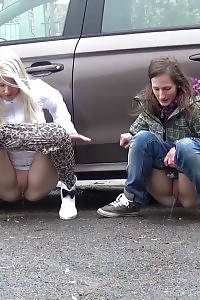 2 Gfs Piss Behind A Parked Vehicle